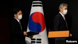 US Special Representative for North Korea, Sung Kim and Noh Kyu-duk, South Korea's Special Representative for Korean Peninsula Peace and Security Affairs, arrive to attend a briefing after their meeting at a hotel in Seoul, South Korea Oct. 24, 2021.