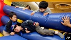 Children play in giant air cushions at the Fantasy Kids Resort in Ebina, west of Tokyo, March 2006.