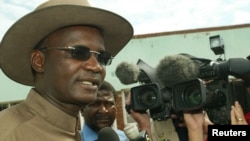 FILE - Former Minister of Information Jonathan Moyo talks to reporters before voting in Tsholotsho, Zimbabwe.