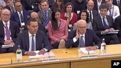 European head of News Corporation James Murdoch and News Corp Chief Executive and Chairman Rupert Murdoch (R) appear before a parliamentary committee on phone hacking at Portcullis House in London, July 19, 2011