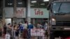 Migrant workers and their families get ready to be taken to a field hospital for COVID-19 patients in Samut Sakhon, South of Bangkok, Thailand on January 4, 2021. AP