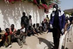 FILE - Street children wait to get meals from members of the Village Pilote association amid an outbreak of the coronavirus disease, in Dakar, Senegal, April 1, 2020.