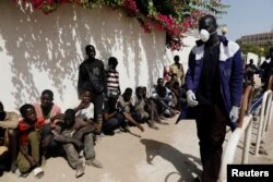 FILE - Street children wait to get meals from members of the Village Pilote association amid an outbreak of the coronavirus disease, in Dakar, Senegal, April 1, 2020.