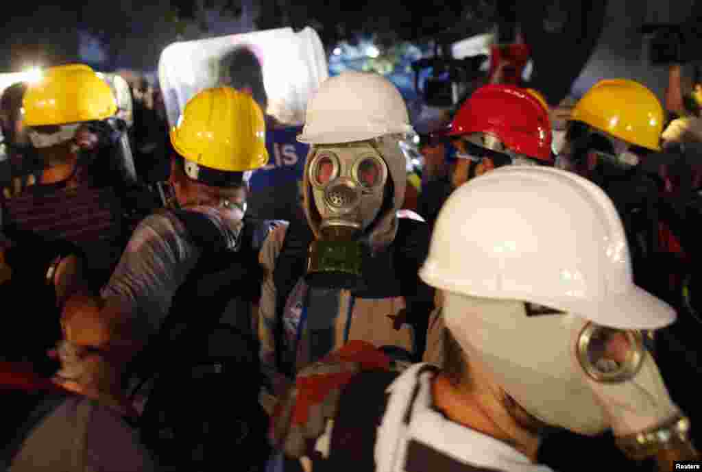 Protesters are evacuated from Gezi Park by riot police at Taksim Square in Istanbul, June 15, 2013.