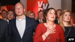 Members of the ruling People's Party for Freedom and Democracy (VVD) react during the Dutch general elections in The Hague on March 15, 2017. 