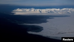 FILE - A general view of snowcapped mountains and the Arctic Ocean on the coast of Svalbard near Longyearbyen, Norway, April 5, 2023.