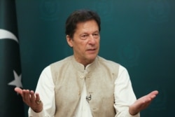 FILE - Pakistan's Prime Minister Imran Khan gestures during an interview with Reuters in Islamabad, June 4, 2021.