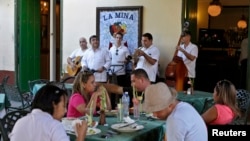 Tourists dine at La Mina state restaurant in Old Havana, Cuba, Dec. 18, 2014. Many Cubans have welcomed President Barack Obama's policy shift, anticipating more tourism and other business.