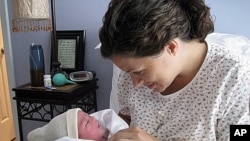 Karen Kramer with daughter, Stella Grace, shortly after giving birth at home.