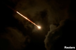 A projectile is seen in the sky after Iran fired a salvo of ballistic missiles, amid cross-border hostilities between Hezbollah and Israel, as seen from Tel Aviv, Israel, Oct. 1, 2024.