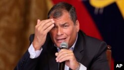 FILE - Ecuador's President Rafael Corrrea gestures during a meeting with the foreign press, in Quito, Ecuador, Jan. 20, 2016. 