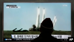 FILE - A man watches a TV screen showing file footage of a missile launch conducted by North Korea, at Seoul Railway Station in Seoul, South Korea, March 21, 2016.