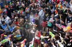 Participants spray water guns at each other during the 3rd Water Gun Festival in Seoul, South Korea, Sunday, July 26, 2015. Thousands of people enjoyed the annual festival which is held from July 25 to July 26 to avoid the summer heat.