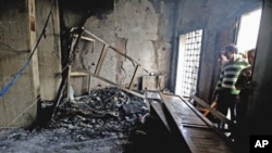 People look at the damage inside a courthouse in Sidi Bouzid, approximately 270 km (168 miles) southwest of the capital Tunis, October 28, 2011.