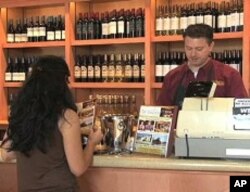A customer pays for wine at the San Antonio Winery store
