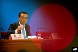 Chinese Premier Li Keqiang speaks during a press conference after the closing session of China's National People's Congress (NPC) at the Great Hall of the People in Beijing, March 20, 2018.