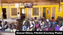 Refugees in the Kakuma Camp in Kenya watch “AIDS: Living in the Shadows” in the waiting area of the camp's main hospital.