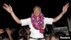 Prime Minister Lee Hsien Loong celebrates his party's election victory with supporters at a stadium in Singapore, Sept. 12, 2015. 