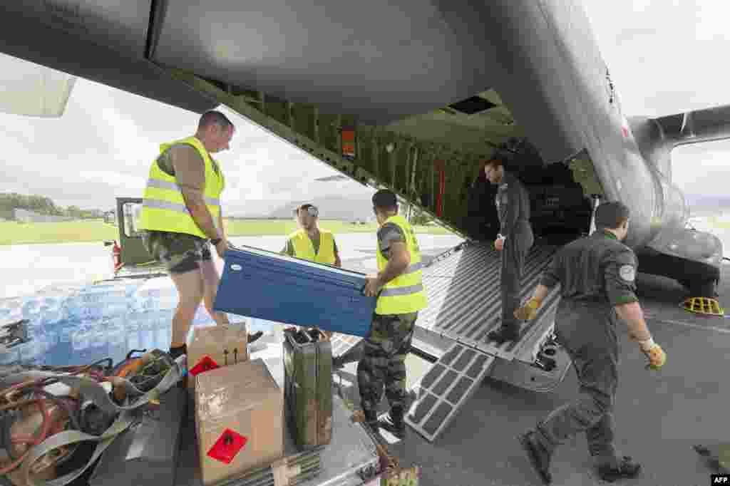 Water bottles and other relief are loaded into a French Army logistical transport plane bound for Vanuatu, at the Aerial Military Base Lieutenant Paul Klein (formerly known as La Tontouta), north of Noumea, New Caledonia, March 15, 2015.