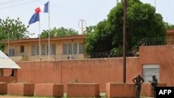 FILE - Officers of the Niger national Police are seen outside the French Embassy in Niamey on August 28, 2023. 