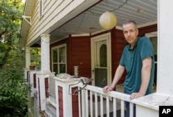 Matt Mason, 48, stands on the porch of his Omaha, Neb., home, July 18, 2017. Mason says the Affordable Care Act led to a huge improvement in covering the costs of treating his Type I diabetes. Before Obamacare he had to rely on state-subsidized coverage and buy a separate policy for his wife and two children. Mason says he'd rather see lawmakers work on ironing out the ACA's problems than "throwing it away and replacing it with some unknown system."