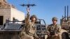 FILE - In this photo from the Defense Visual Information Distribution Service, British soldiers launch a drone during Project Convergence exercises at Fort Irwin, Calif., on Nov. 4, 2022.