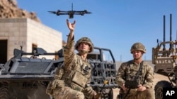 FILE - In this photo from the Defense Visual Information Distribution Service, British soldiers launch a drone during Project Convergence exercises at Fort Irwin, Calif., on Nov. 4, 2022.