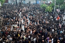 In this picture taken on May 4, 2021, Shiite Muslim devotees take part in a procession to commemorate the death anniversary of Prophet Mohammad's companion and son-in-law Imam Ali in Lahore.