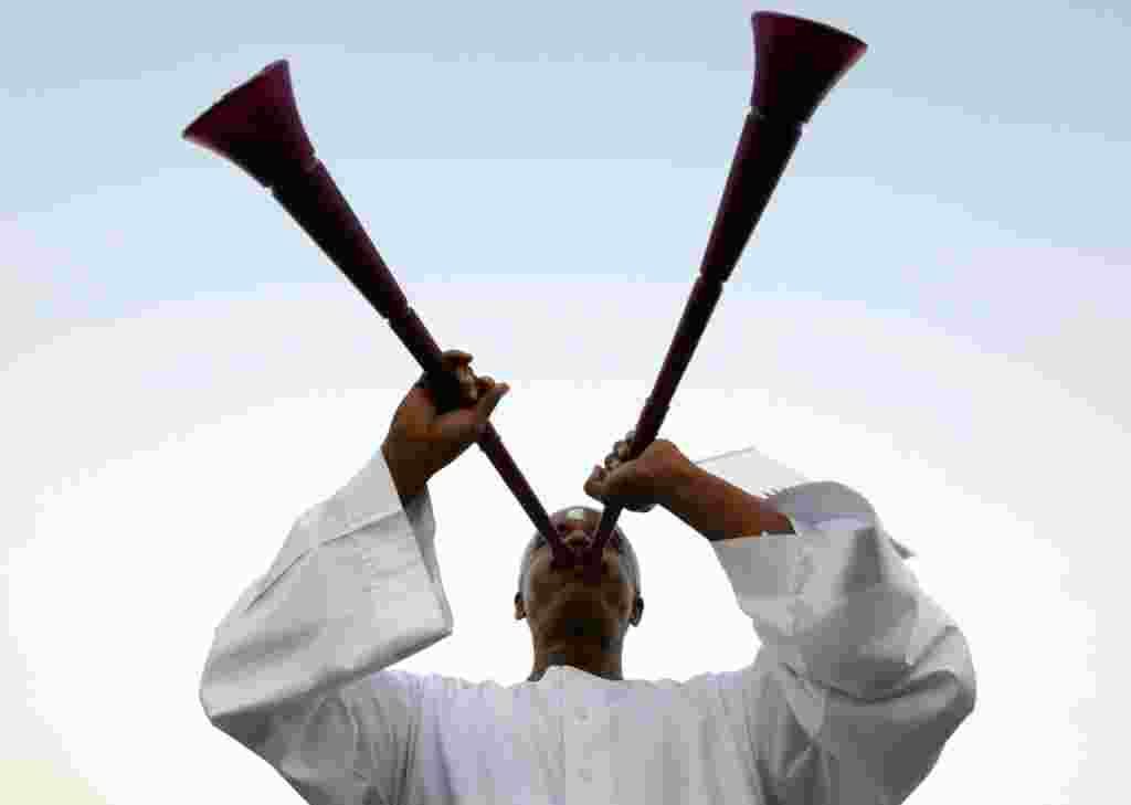 A Qatari soccer fan blows a vuvuzela before the announcement of the hosts for the 2022 World Cup, in Souq Waqif December 2. (Fadi Al-Assaad/Reuters)