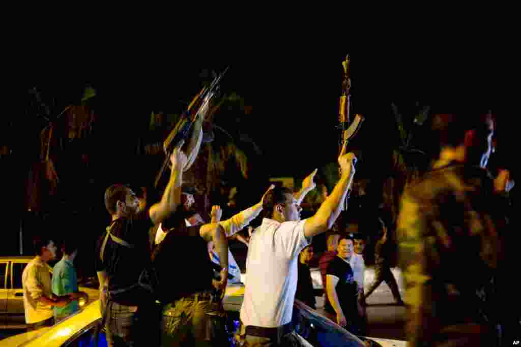 Syrian security personnel celebrate Bashar al-Assad&#39;s presidential re-election in Damascus, June 4, 2014.