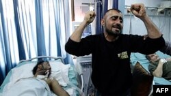 A Syrian man reacts in dispair to his brother's condition: seriously wounded during violence between security forces and armed groups in Latakia, northwest of Damascus, March 27, 2011