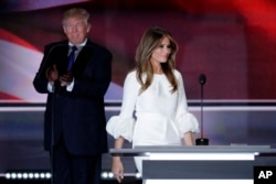 Melania Trump, wife of Republican Presidential Candidate Donald Trump walks to the stage as Donald Trump applaudss during the opening day of the Republican National Convention in Cleveland, July 18, 2016.
