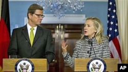 Secretary of State Hillary Rodham Clinton gestures during a news conference with German Foreign Minister Guido Westerwelle, at the State Department in Washington, January 20, 2012.