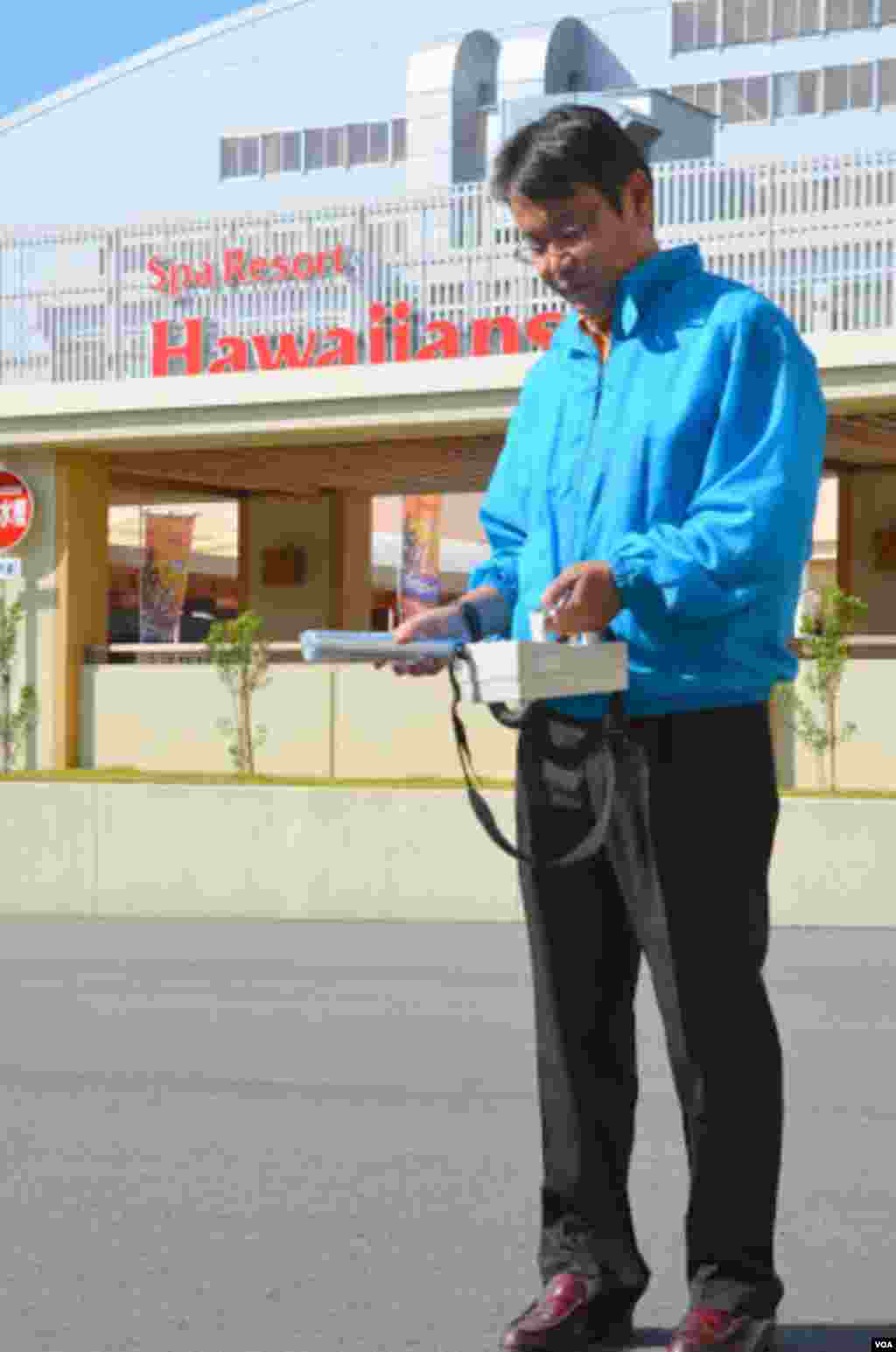 Resort safety director Takeshi Namatame is on the grounds daily with a geiger counter, (Steve Herman/VOA)
