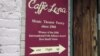 A sign announcing Caffè Lena