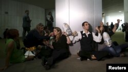 Demonstrators handcuff themselves to each other during a protest calling for the impeachment of Brazil's President Dilma Rousseff at the National Congress in Brasilia, Oct. 28, 2015.