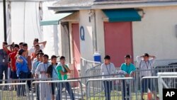 Children line up to enter a tent at the Homestead Temporary Shelter for Unaccompanied Children in Homestead, Florida, Feb. 19, 2019.