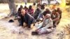 Elders light a fire at a border post in eastern Namibia.