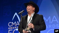 Garth Brooks, winner of the award for entertainer of the year, participates in an interview in the press room at the 50th annual CMA Awards at the Bridgestone Arena in Nashville, Tennessee, Nov. 2, 2016.