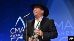 Garth Brooks, winner of the award for entertainer of the year, participates in an interview in the press room at the 50th annual CMA Awards at the Bridgestone Arena in Nashville, Tennessee, Nov. 2, 2016.