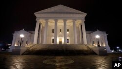 The State Capitol is illuminated in Richmond, Va., Feb. 6, 2019. 