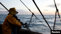 FILE - A fisherman on a Boulogne sur Mer-based trawler prepares to raise fishing nets off the coast of northern France, Oct. 21, 2013. Fishermen will not get European Union subsidies to build new vessels, E.U. lawmakers agreed on October 23, 2013. 