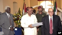Sudanese President Omar Al Bashir, centre, holds the draft interim constitution for Sudan, in Khartoum, June 26, 2005, with the President of the Constitutional Court Judge Galal Ali Lutfi, right, and the Chairperson from Southern Sudan Abel Alair, left. (