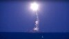 FILE - In this photo made from the footage taken from Russian Defense Ministry official website, a Russian navy ship on the Caspian Sea launches a cruise missile toward Islamic State targets in Syria, the ministry said, Oct. 7, 2015.