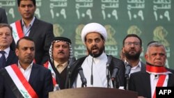 FILE - Qais al-Khazali (C) leader of the Asa'ib Ahl al-Haq, one of the units of the Hashed al-Shaabi (Popular Mobilisation units) gives a speech during a campaign rally for the Fateh Alliance, in Baghdad, May 7, 2018. 