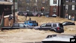 Una inundación recorre la avenida principal de Ellicott City, Maryland, el domingo 27 de mayo de 2018. (Libby Solomon/The Baltimore Sun vía AP) 