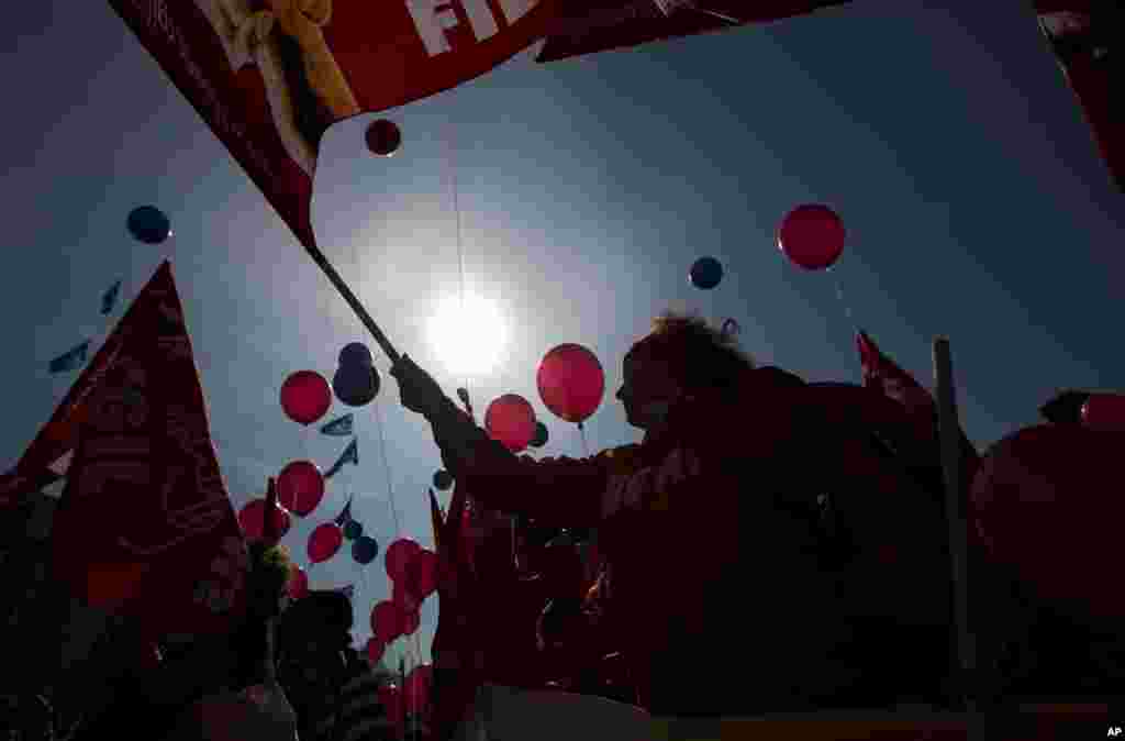 Protesters hold balloons and flags during a demonstration in Rome. Italian hospitality and other service workers gathered to ask for the renewal of the national contact.
