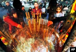 Celebrants light incense at the Thien Hau temple in Los Angeles, Jan. 28, 2017, the first day of the Lunar New Year - the Year of the Rooster.