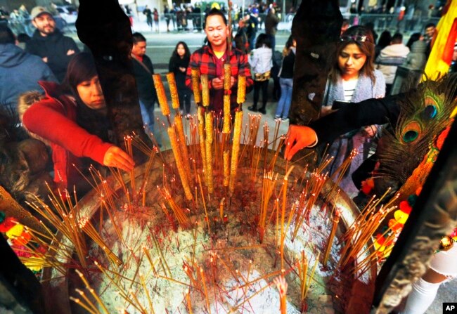 Celebrants light incense at the Thien Hau temple in Los Angeles, Jan. 28, 2017, the first day of the Lunar New Year - the Year of the Rooster.