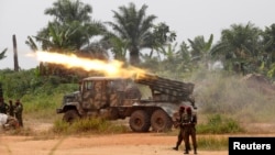 FILE - Democratic Republic of Congo soldiers are seen launching missiles during their military operation against ADF rebels outside the town of Beni, in North Kivu province, Jan. 18, 2014.